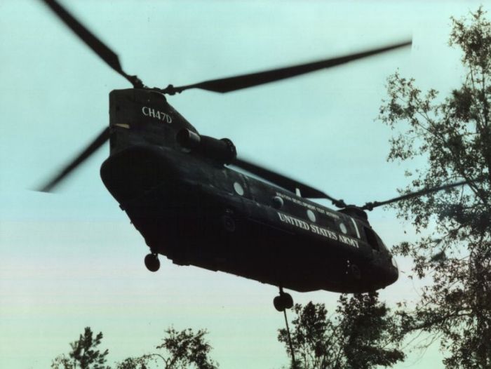 Notice the sling hanging down in this picture (appears to be coming from the left forward landing gear). The crew was retrieving a 16,000 pound concrete block dropped during flight when someone accidentally hit the release button during the transfer of the flight controls between the two pilots in the cockpit.