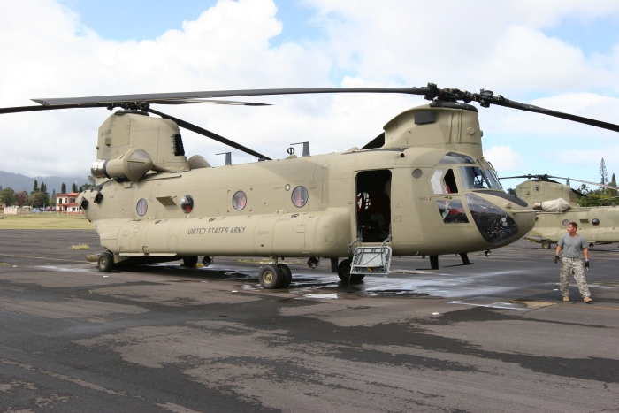 8 December 2011: CH-47F Chinook helicopter 08-08766 rests on the Army National Guard ramp at Wheeler Army Airfield, Oahu, Hawaii, as CW2 Dave Ofak conducts the preflight during his aircraft qualification training.