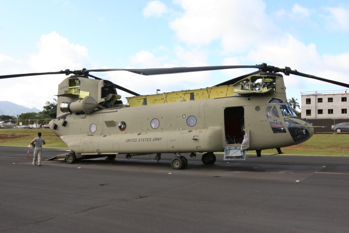 10 December 2011: SGT Josh Pastor, Flight Engineer, readies CH-47F Chinook helicopter 08-08767 for a Night Vision Goggle (NVG) and Heads Up Display (HUD) training flight on the Army National Guard ramp at Wheeler Army Airfield, Oahu, Hawaii. 08-08767 was transferred to Company B - "Voyagers", 171st Aviation, in late November and utilized by members of the S3 Incorporated New Equipment Training Team (NETT) to support the aircraft qualification of unit aircrew members.