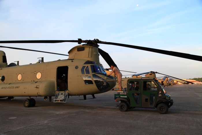 10 April 2012: We are not sure how many guys it takes to wash the windows on a Chinook helicopter. However, Flight Engineer Andrew "Manny" Manuel gets the task accomplished with what ever resources he can find.