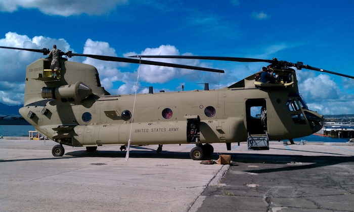 20 November 2010: CH-47F Chinook helicopter 09-08067 on the dock across from the USS Missouri at Pearl Harbor, Hawaii. Boeing maintenance personnel are installing the rotor blades and preparing the aircraft for movement up the hill the Wheeler Army Airfield.