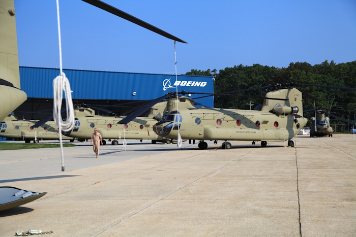 11 September 2013: New Equipment Training Team (NETT) Standardization Pilot Tim McCall walks past CH-47F Chinook helicopter 12-08103 as it rests on the ramp at the Boeing Millville facility, Millville Municipal Airport (KMIV), New Jersey, awaiting movement to the Port of Baltimore for ship transport to the Republic of Korea.