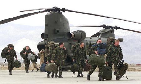 Royal Air Force ground crew members and technicians walk across the tarmac at Bagram Air Base in Afghanistan.