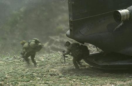 Members of a coalition force disembark from a CH-47D Chinook