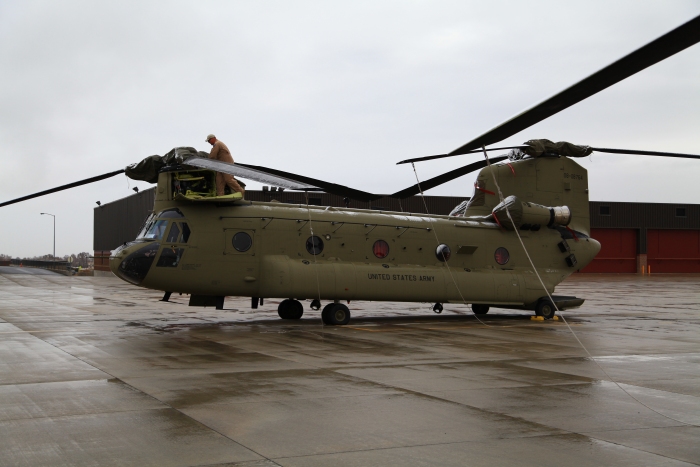 Rob Simpson, NET Team Standardization Instructor and Lead Man for the Flight Engineers prepares CH-47F Chinook helicopter 08-08764 for flight at Helena Airport, Montana.