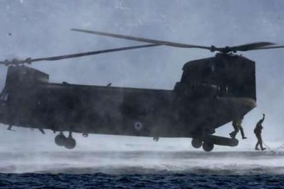 Greek special forces jump out of a Chinook helicopter as they conduct an exercise at the military camp of Nea Peramos, 20 miles west of Athens on Monday. Greece's elite special forces held land and sea exercises as U.S. and Greek troops plan to stage joint exercises in Greece beginning in March as part of security preparations for the Athens Olympic Games. Defense Minister Yiannos Papantoniou, attending the exhibition, told reporters that NATO countries are involved in the security planning of the August 13-29 Games, and will be ready to intervene if a crisis erupts.