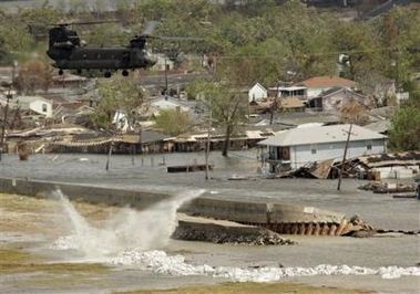 Dropping the sandbags creates quite a splash as they hit the water flowing over the levee.