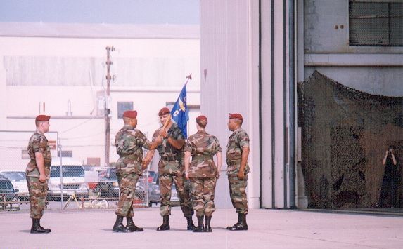 Major Peri A. Anest prepares to pass the flag...