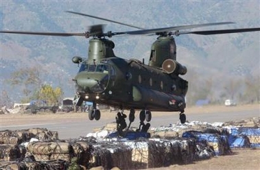 16 November 2005: British soldiers prepare airlift of tents, food and other supplies to earthquake victims by a British CH-47 Chinook helicopter at an airport in Muzaffarabad, Pakistan, on Wednesday. Two British military helicopters on Wednesday joined an increasingly urgent push to send supplies to survivors of last month's earthquake that killed more than 86,000 people and devastated large parts of mountainous northern Pakistan.